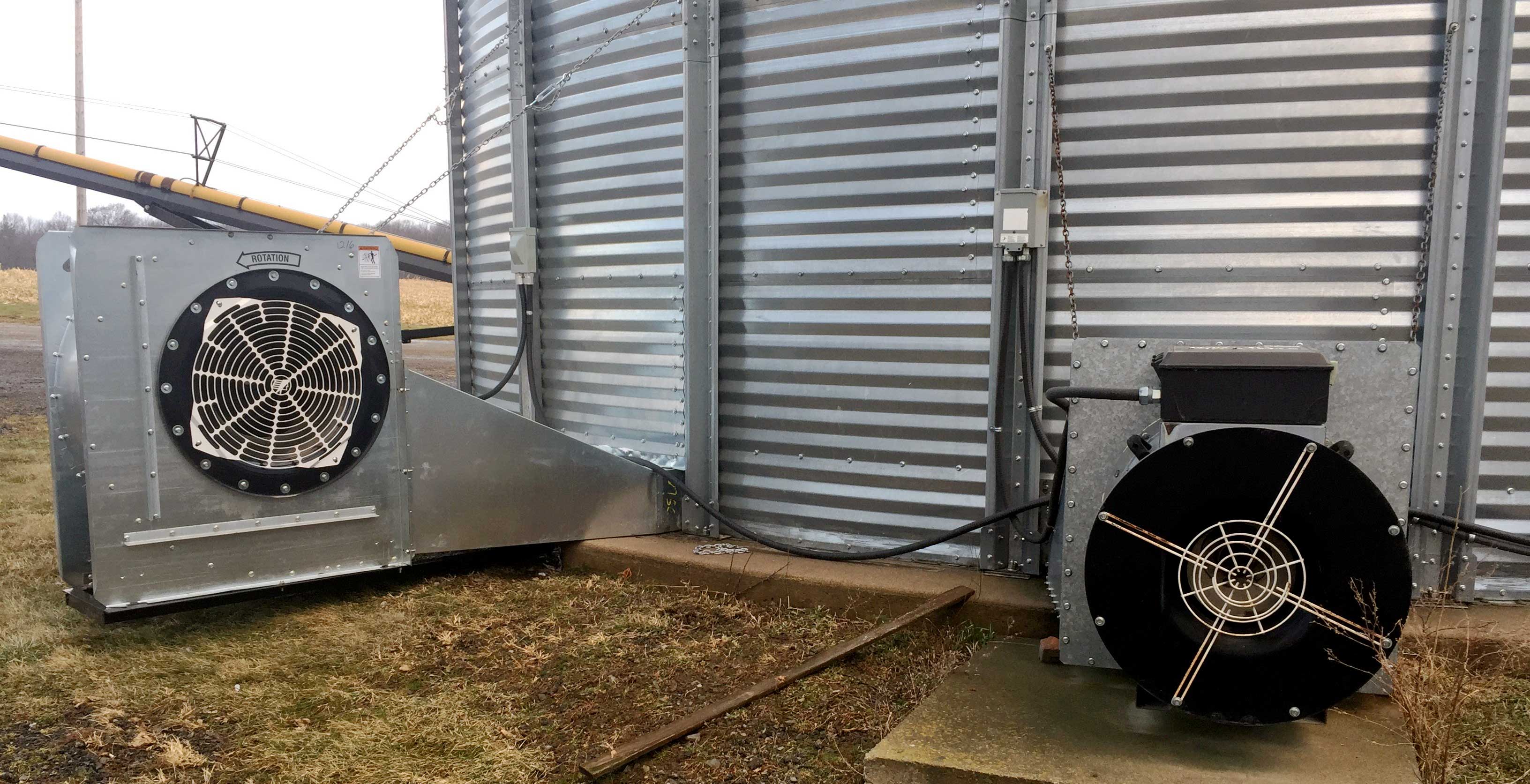 This photo shows a grain bin used for natural air drying. This bin has two fans installed to increase the airflow rate for faster drying.