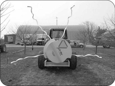 This photograph shows how ribbons tied to the highest and lowest nozzle position on the boom can indicate where spray-laden air will go when the fan is engaged.