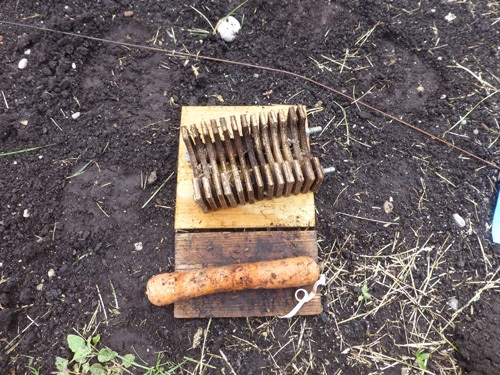 Disassembled Boivin weevil trap. A base, top, middle section with wooden slats, carrot piece, flag and rubber band.