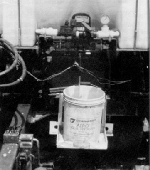 Injection system on a tomato transplanter for uniform application of starter fertilizer in planting water.
