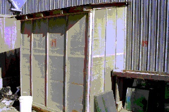 Intake fan with screened frame outside the greenhouse.