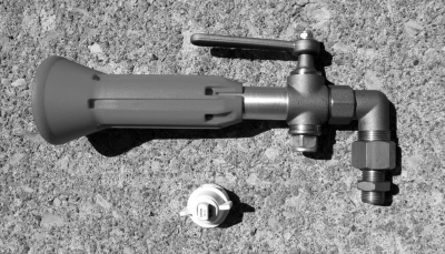 This photograph shows the two nozzle types tested in this study. The larger unit is the ARAG hollow-cone assembly, which features a ball valve and adjustable sheath, but is essentially a hollow cone nozzle. It does not employ air-assist or air-induction. The smaller unit is a dual-fan tip that produces two parallel 80 degree fans.