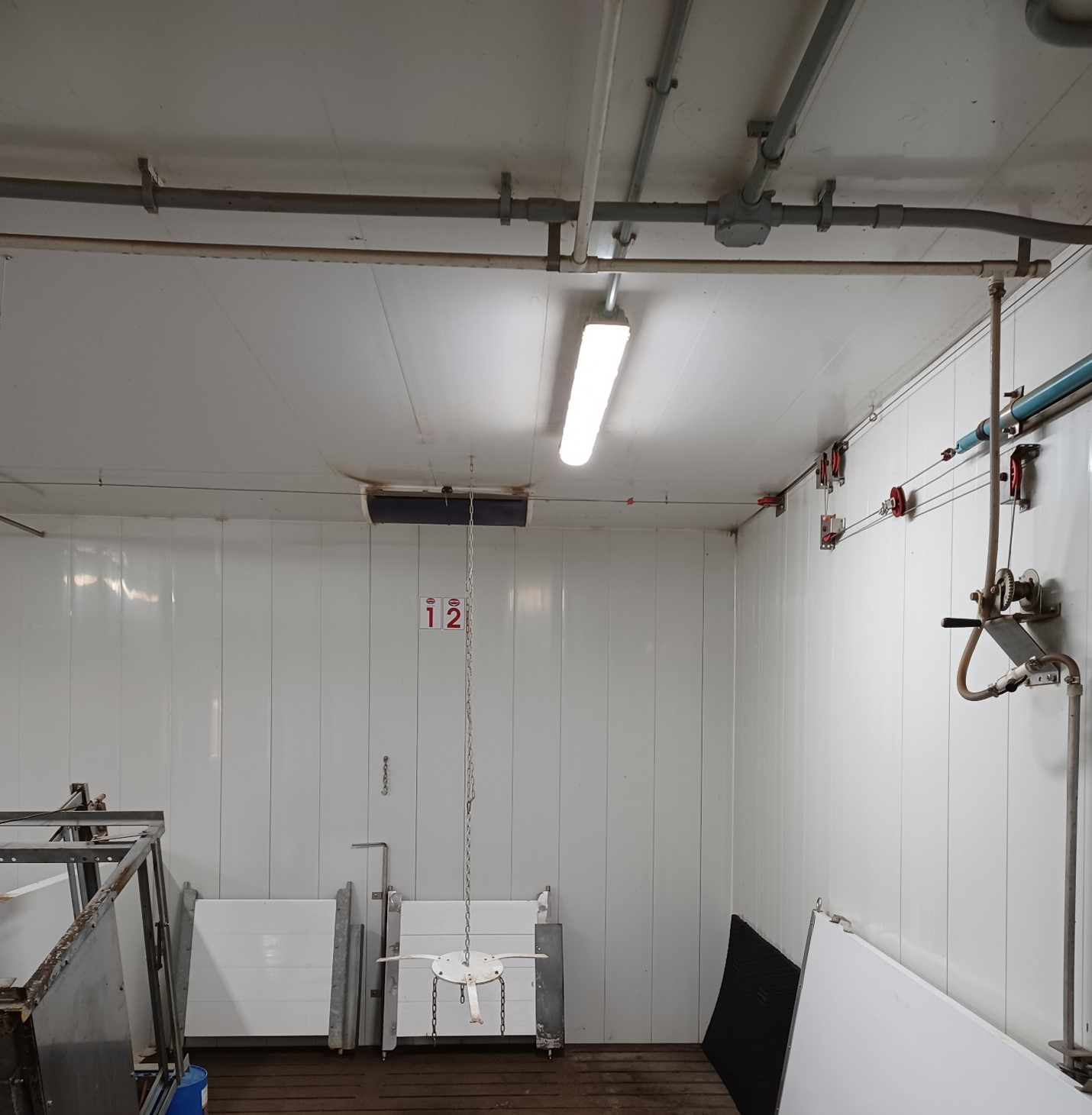 A finisher barn room showing a linear light fixture on the ceiling.