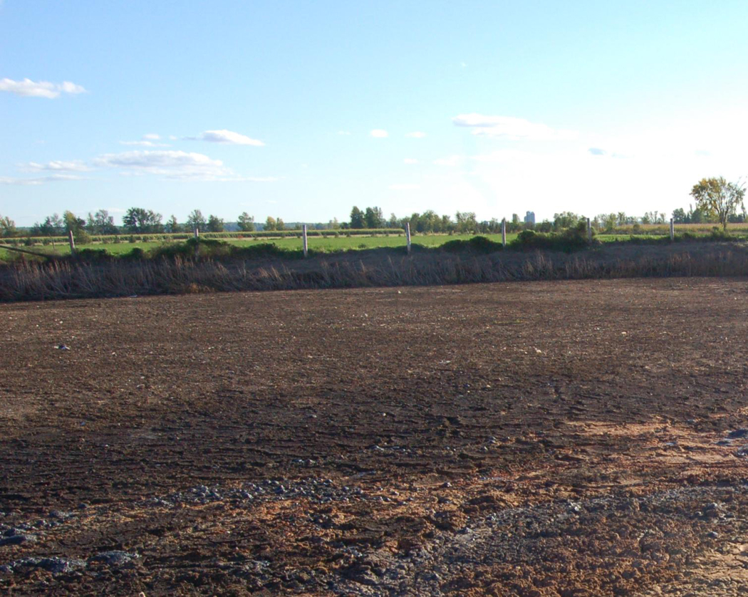 An earthen permanent digestate storage that resembles common permanent liquid manure storages used on dairy farms.