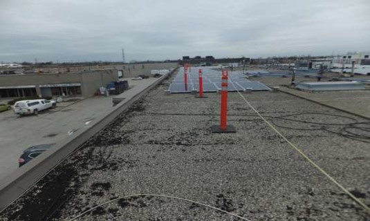 Example of incorrect use of a barrier where only bump lines  are being used but work installing solar panels will be within 2m of the edge  of the roof.