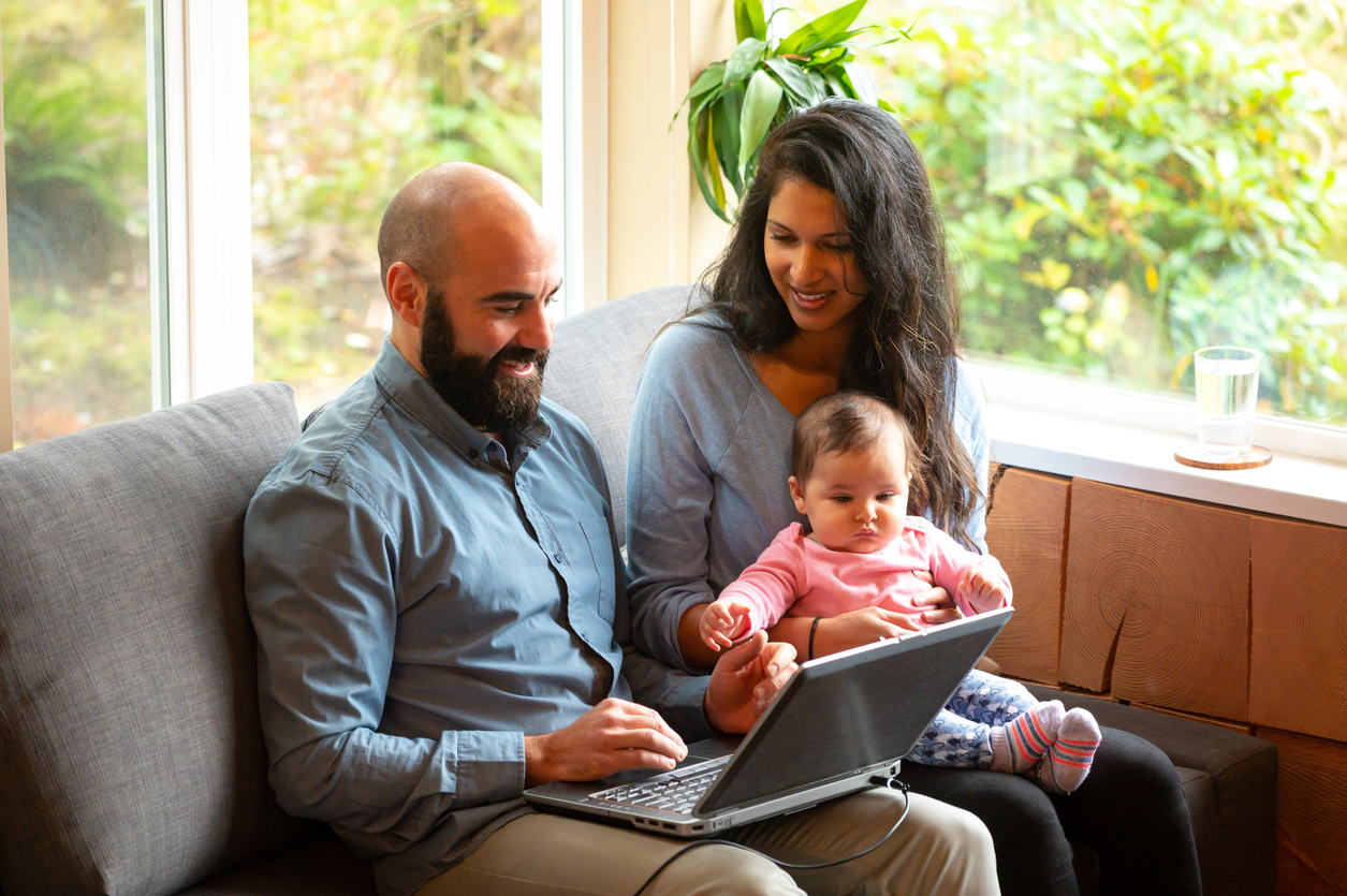 Couple going over home finances with a newborn