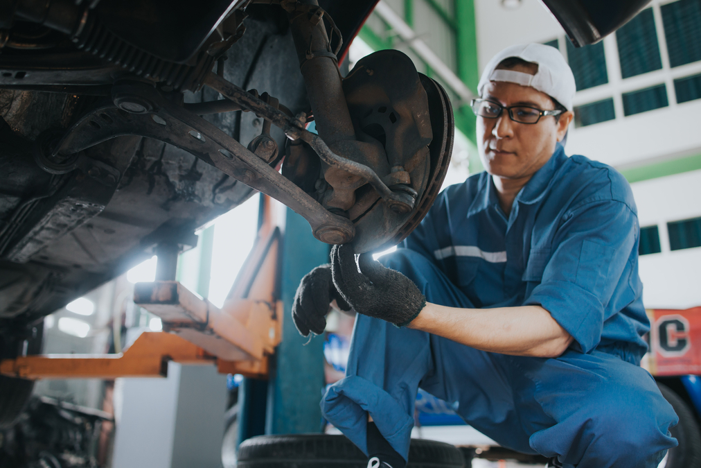 A mechanic working on a car