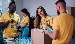 Photo of three volunteers taking stock of emergency supplies