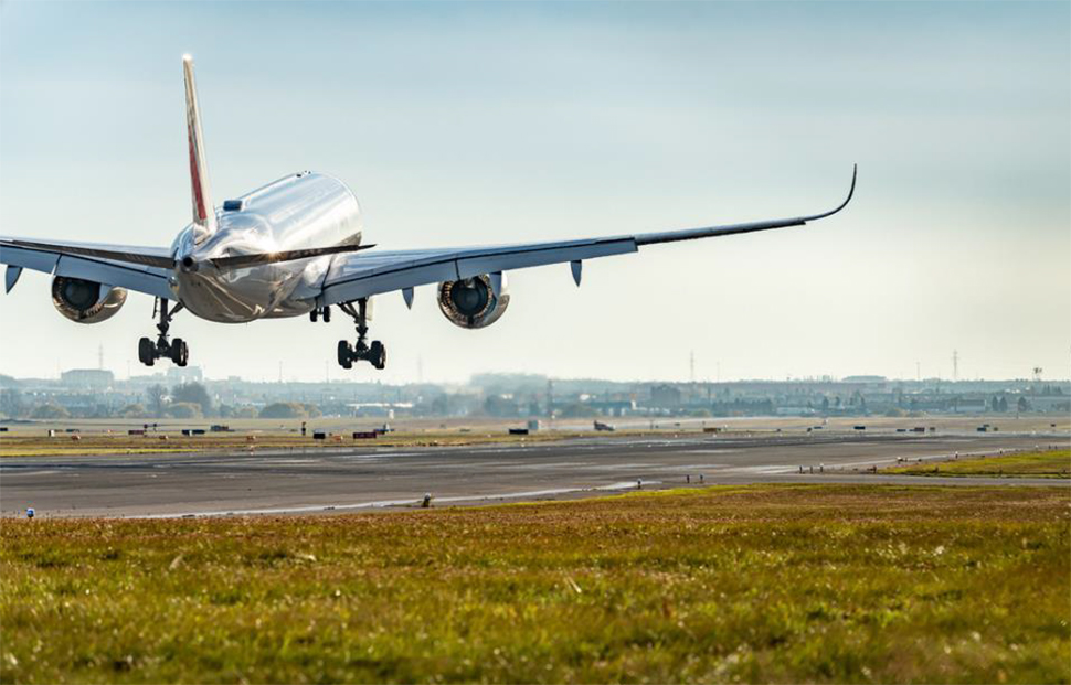 Plane landing on airport runway.