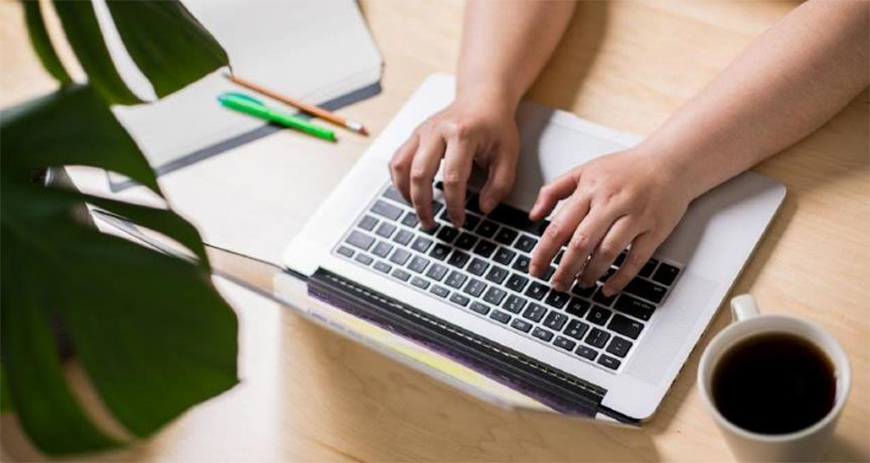 A person typing on a laptop.