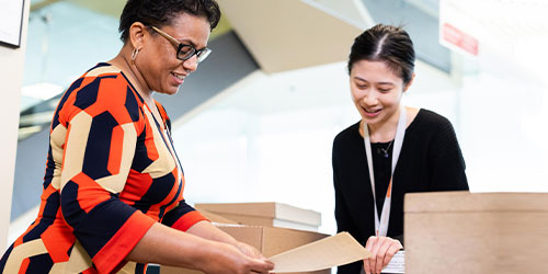 Two women working together in an office.