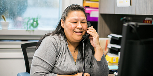 Indigenous woman working at a desk in an office