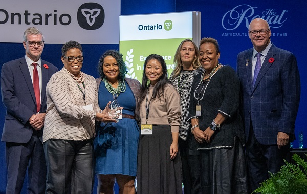 An image of people from Foodpreneur Lab receiving an Excellence in Agriculture Award in 2024.
