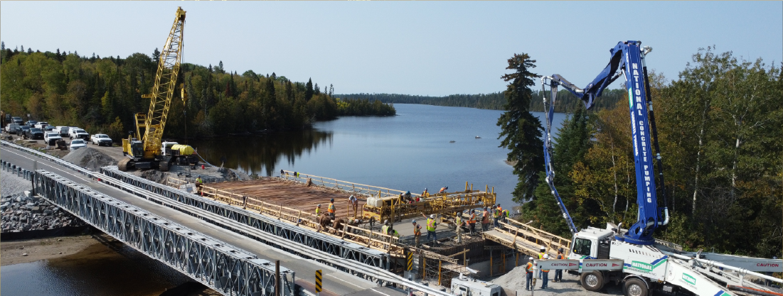 A bridge under construction  spanning a river