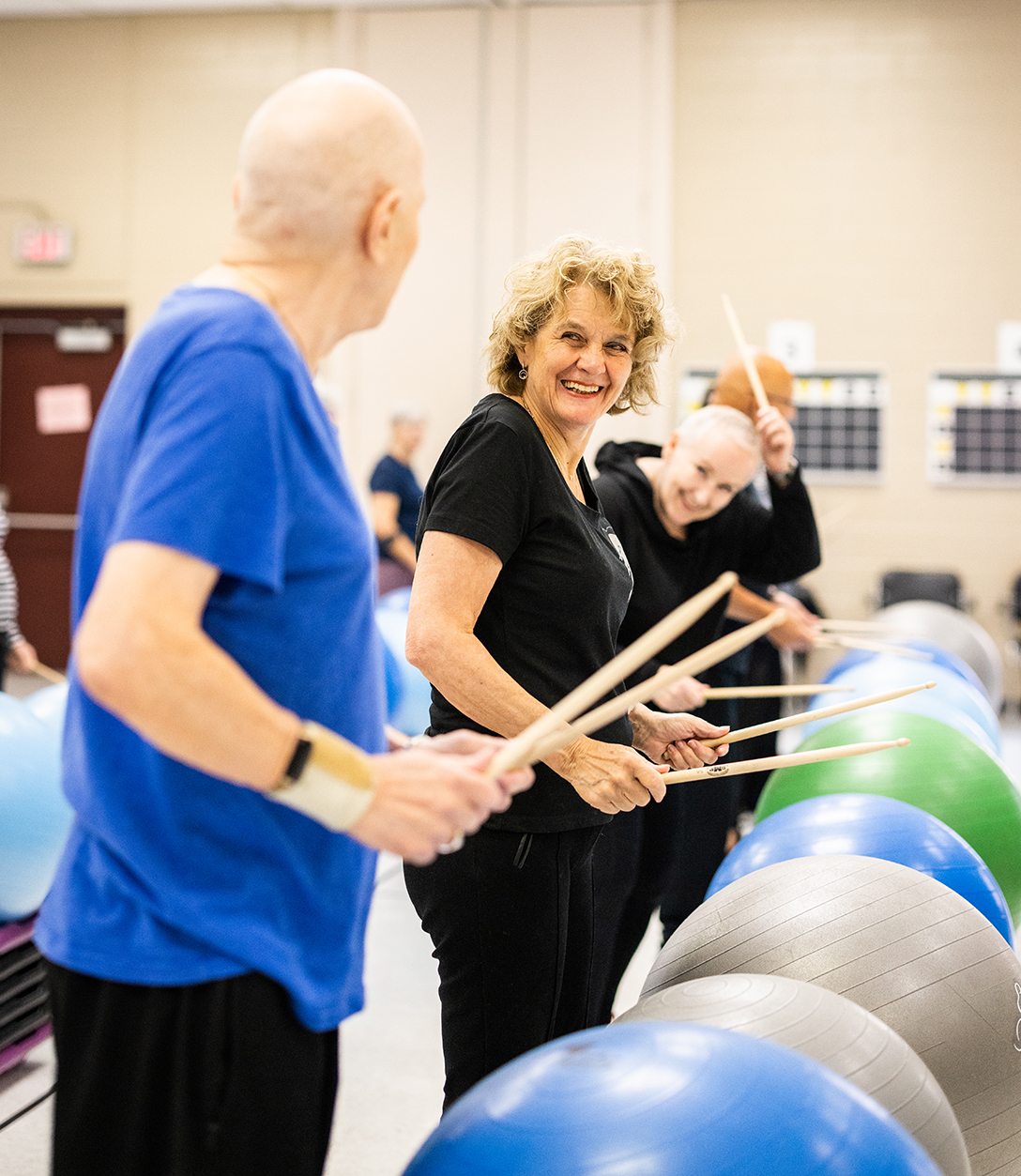 Older adults participating in an exercise drumming class.