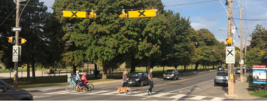 Photo of pedestrians crossing the street at a crosswalk