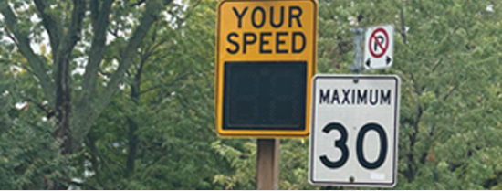 Photo of a speed radar sign displaying the text “your speed” next to a 30 km/h speed limit sign