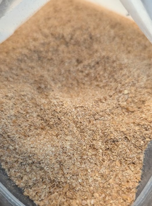 A photo of ground oat hulls used for pig feed.