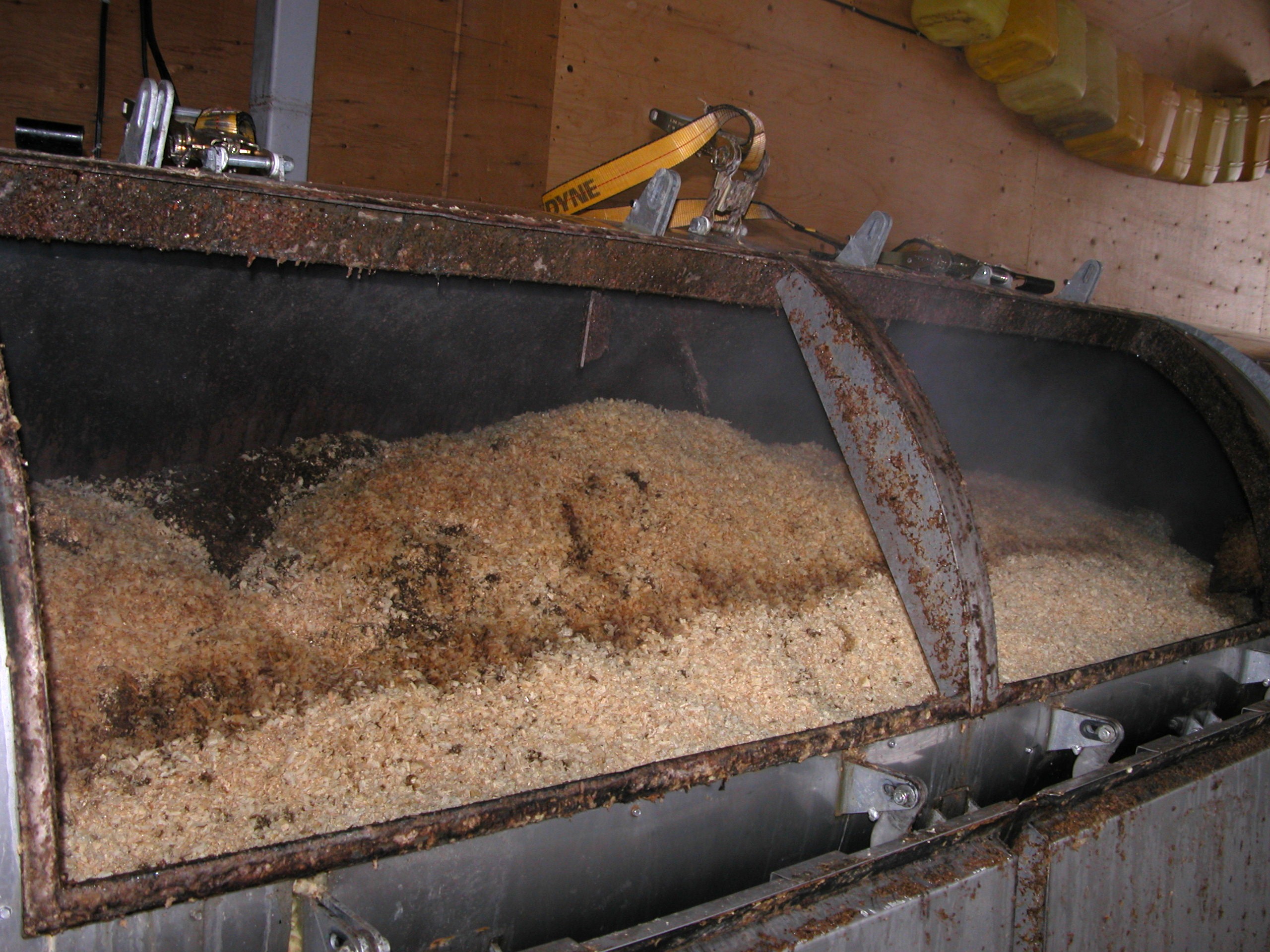 the interior of a disposal bin with wood shavings as a substrate for composting